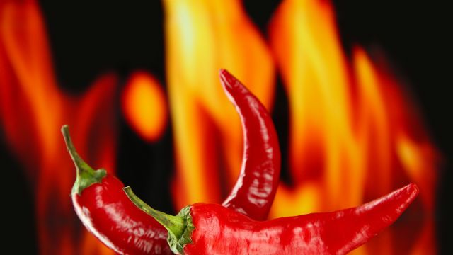 Red hot chili peppers on fire background