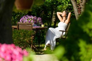 Woman resting in garden on summer