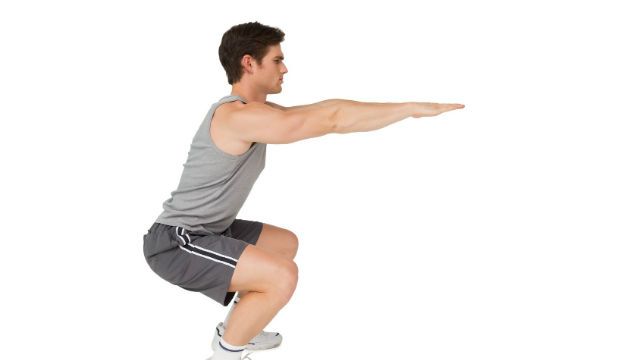 Fit man doing squats