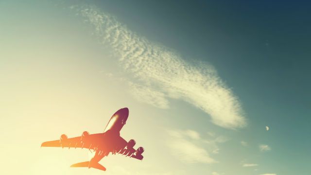 Airplane taking off at sunset.