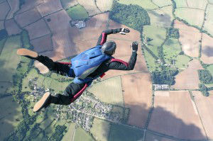 Skydiver in freefall high up in the air