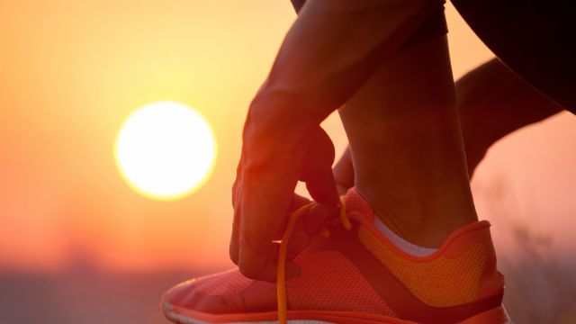woman tying shoelaces outdoor