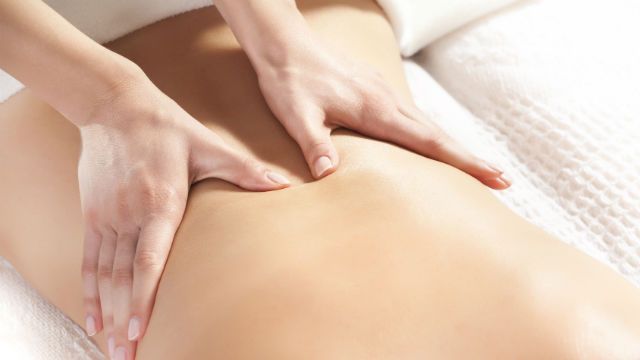 woman giving back massage to a girl