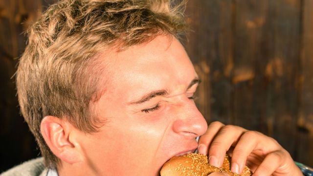 Handsome Man eating Cheeseburger