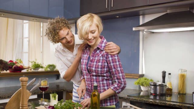 A couple cooking in the kitchen.