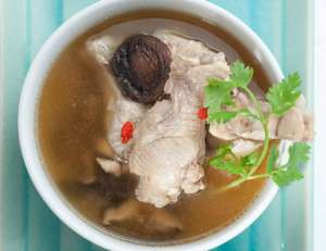 Traditional oriental chicken broth with mushrooms