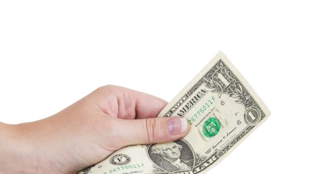 Hand holding money dollar isolated on white background