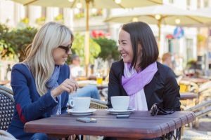 Two female friends meeting for a coffee
