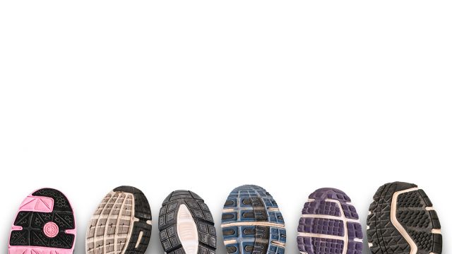 Different shoe sole on a grey background.