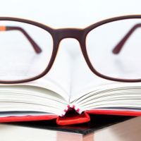 Eyeglasses closeup on open book