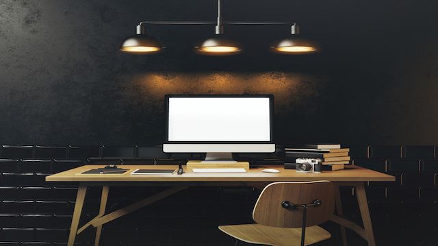 Mock up of generic design computer screen. Workspace in the black loft with vintage tiles on the wall. 3D rendering