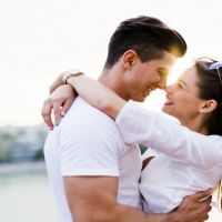 Young beautiful couple hugging and about to kiss