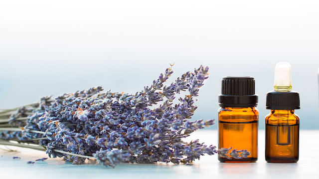 Essential oils in bottles with lavender