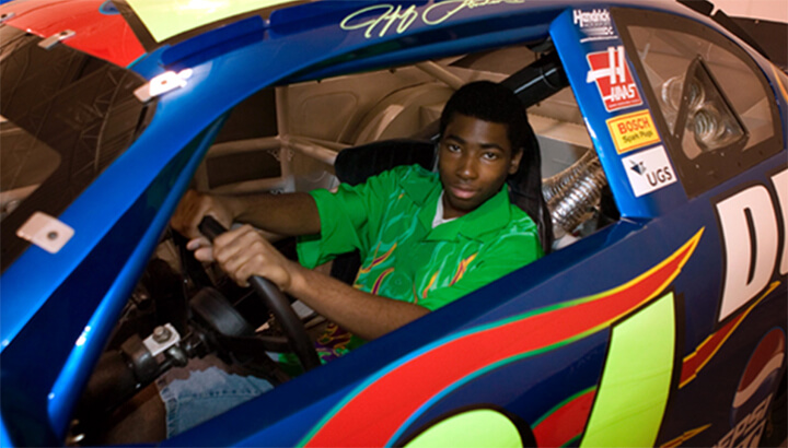 Allan, age 17, sits behind the wheel of NASCAR champion Jeff Gordon’s #24 DuPont Chevy Monte Carlo race car. (Photo Courtesy Make-A-Wish)