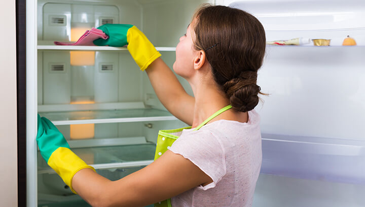 Clean your refrigerator with a natural solution of vinegar and essential oils.