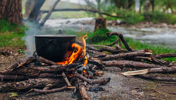 Distill saltwater with a cooking pot over a fire.