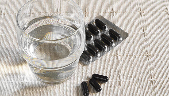 Taking an activated charcoal supplement with alcohol is said to reduce symptoms of a hangover.
