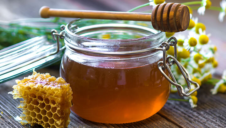 Raw honey in coffee adds a sweet flavor and provides health benefits.