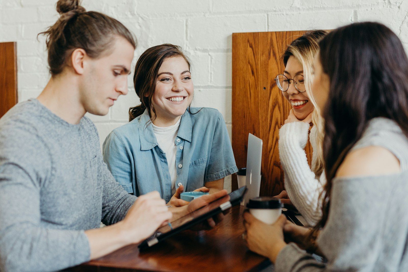 Friends laughing together at a coffee shop